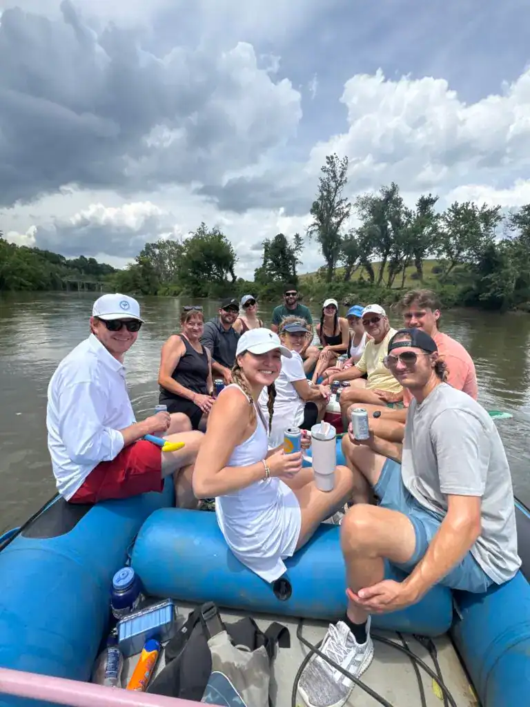 Adventurous group enjoying a scenic river rafting trip with Cedar Rock Adventures.